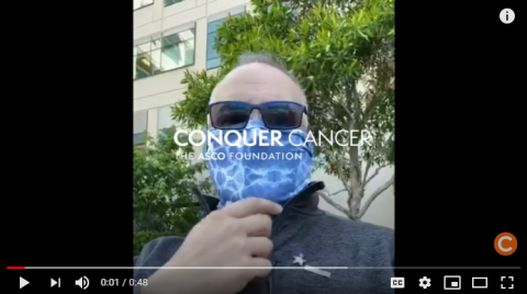 Mark Crafts wearing a bandana outside of the hospital where he receives treatment for cancer. Screenshot linking to his YouTube video.