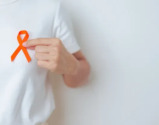 Person holding an orange ribbon