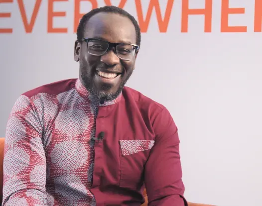 Dr. Thomas Odeny sitting in chair