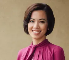 Dr. Chi Viet headshot, smiling facing forward against a tan background.