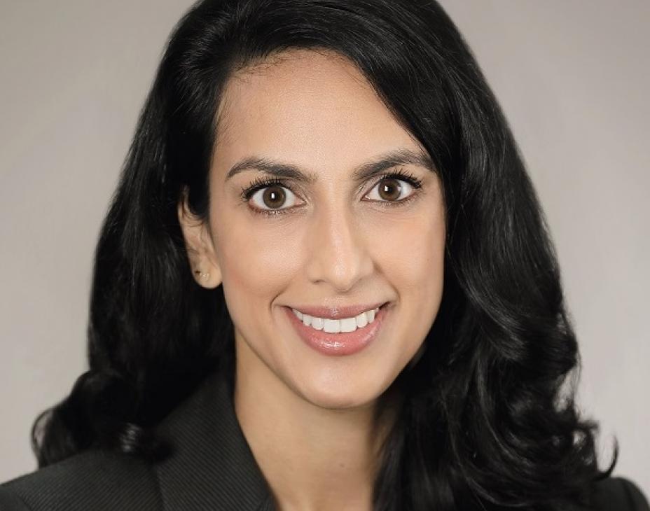 Dr. Lekha Mikkilineni smiling facing forward. She is wearing a black blazer and has long black hair.