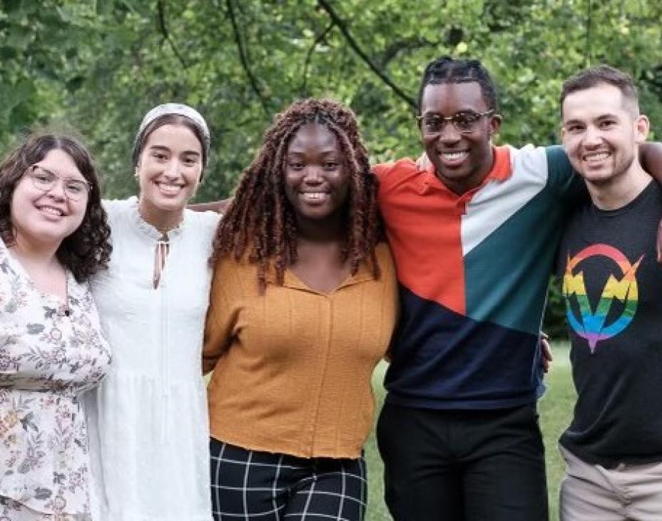Five interns from the Oncology Summer Internship program. They are standing side by side in a green outdoor/park environment.