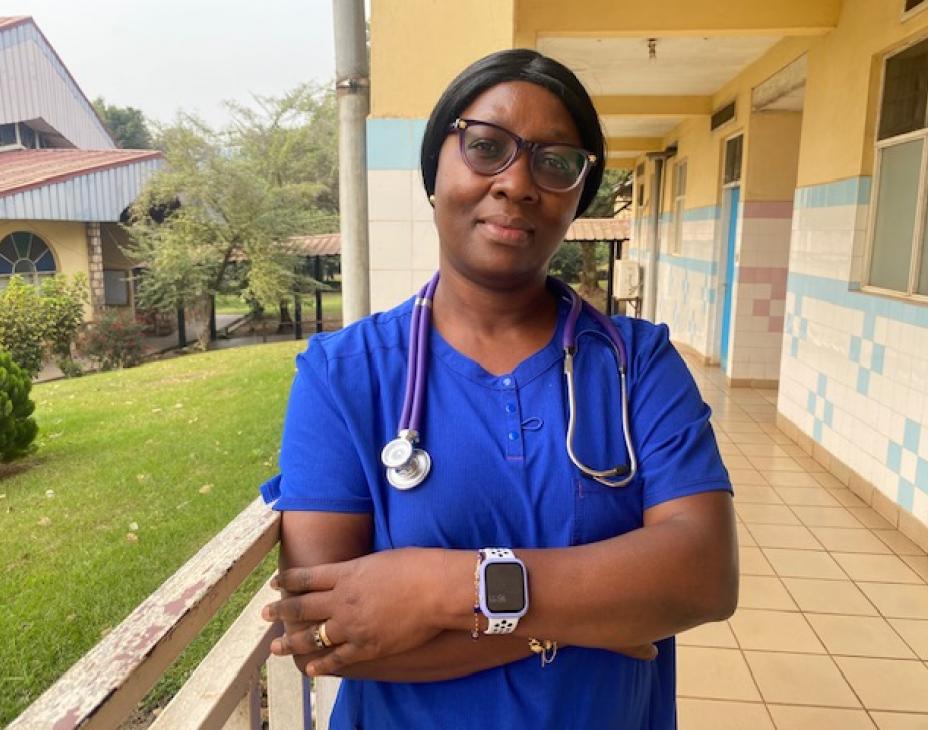 Dr. Kouya Francine, smiling facing forward. She is wearing a blue shirt and stethoscope.