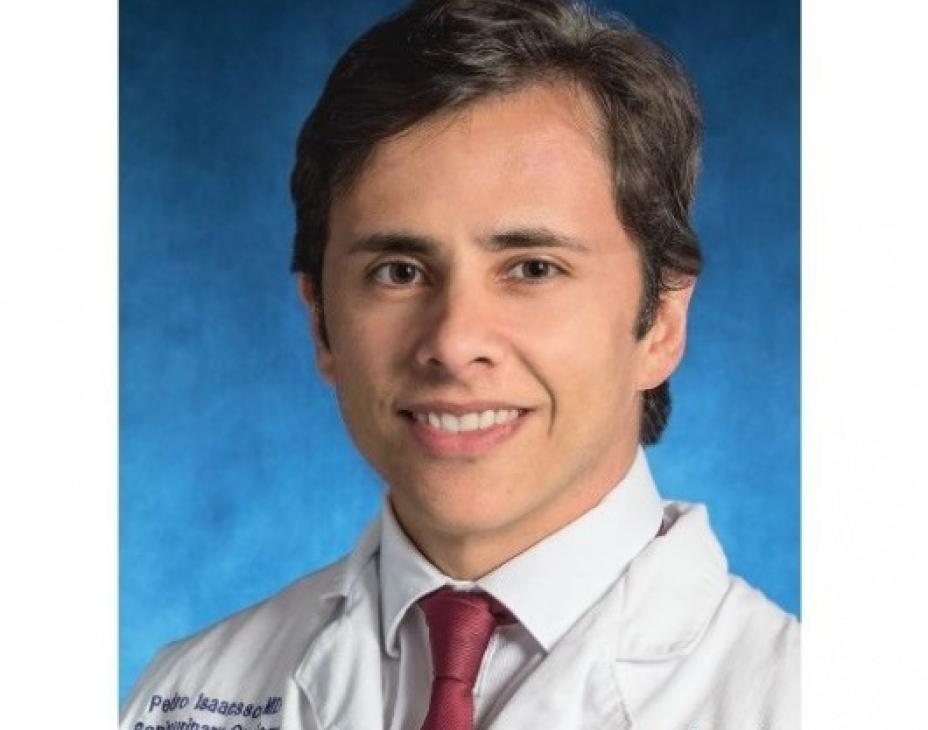 Dr. Pedro Isaacsson Velho in a white coat, smiling facing forward against a blue background.