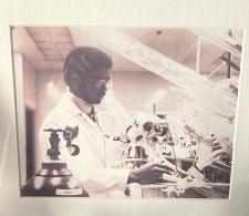 Dr. Clyde Yancy vintage photo in sepia color. He's in a research laboratory.