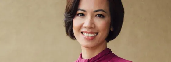 Dr. Chi Viet headshot, smiling facing forward against a tan background.