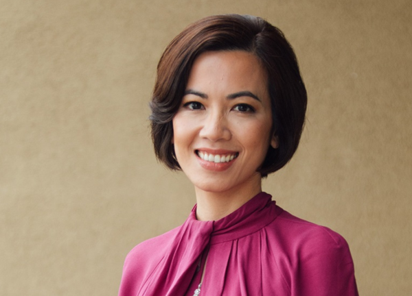 Dr. Chi Viet headshot, smiling facing forward against a tan background.