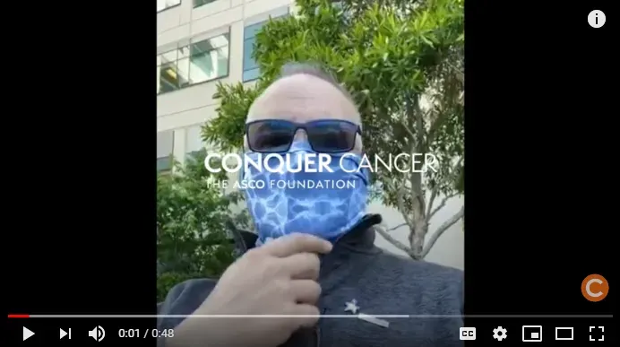 Mark Crafts wearing a bandana outside of the hospital where he receives treatment for cancer. Screenshot linking to his YouTube video.