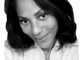 Monique Robinson smiling facing forward. The image is a black and white close-up of Monique's face.