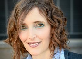 A headshot of Dr. Shlomit Strulov Shachar smiling facing forward, wearing a blue collared shirt.