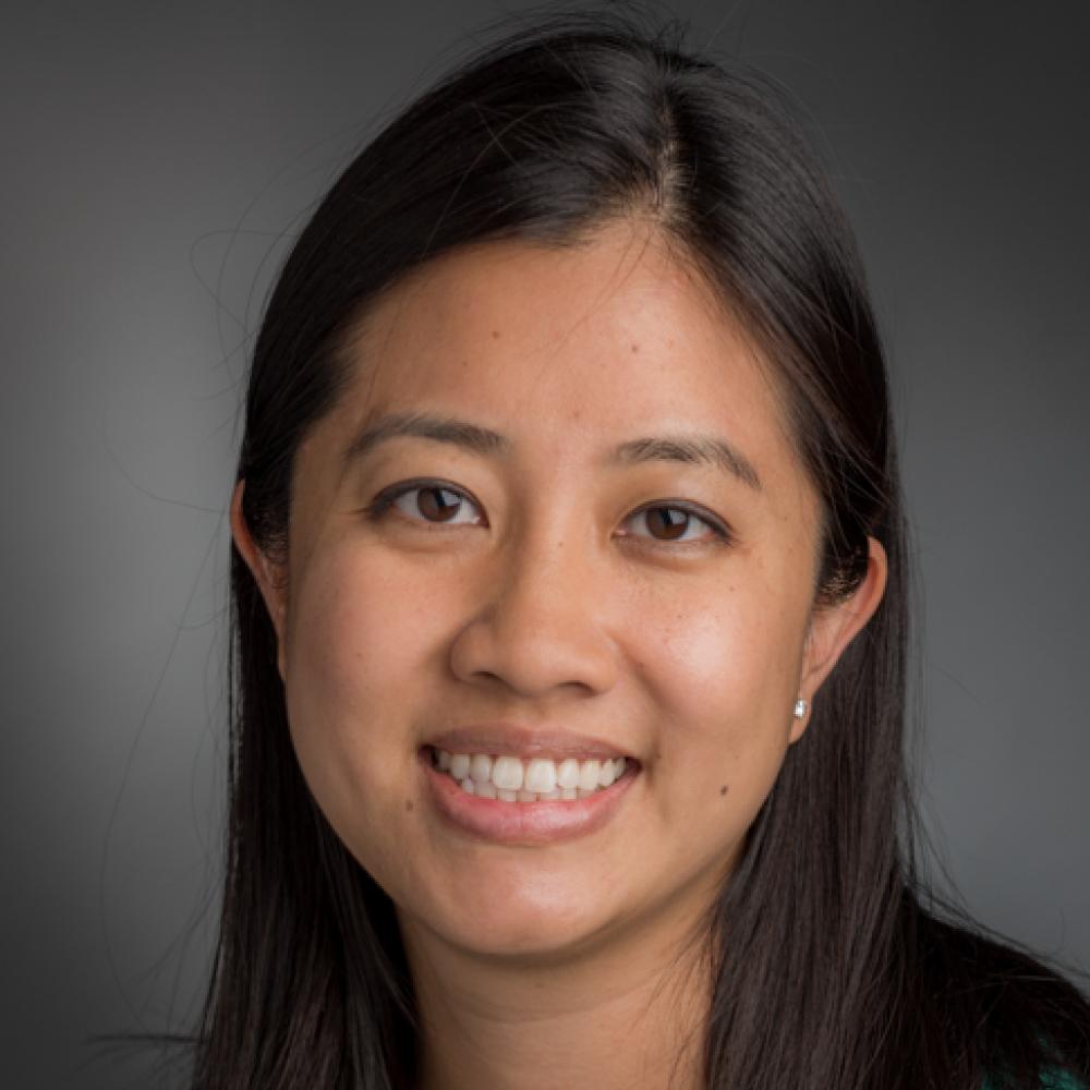 Headshot of Dr. Jacqueline Garcia. She has long dark-brown hair and is smiling facing forward, pictured from the neck up.