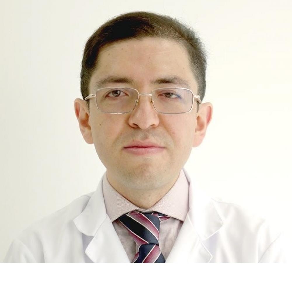 Dr. Luis L. Rojas Puentes headshot. He is smiling facing forward against a white background.