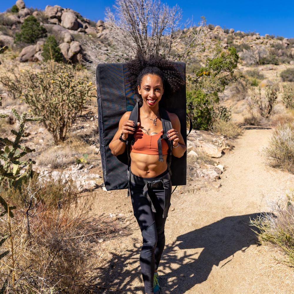 Dr. Favia Dubyk backpacking outdoors in a desert environment.