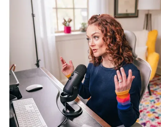 Kristin Flanary speaking into a microphone at her desk.