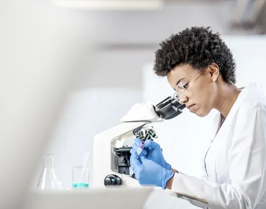 Scientist looking at vial of blood